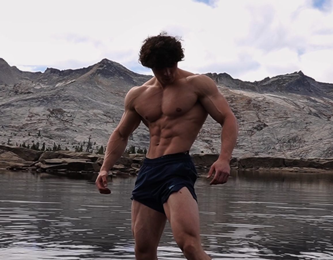 Ben standing at an alpine lake in the mountains